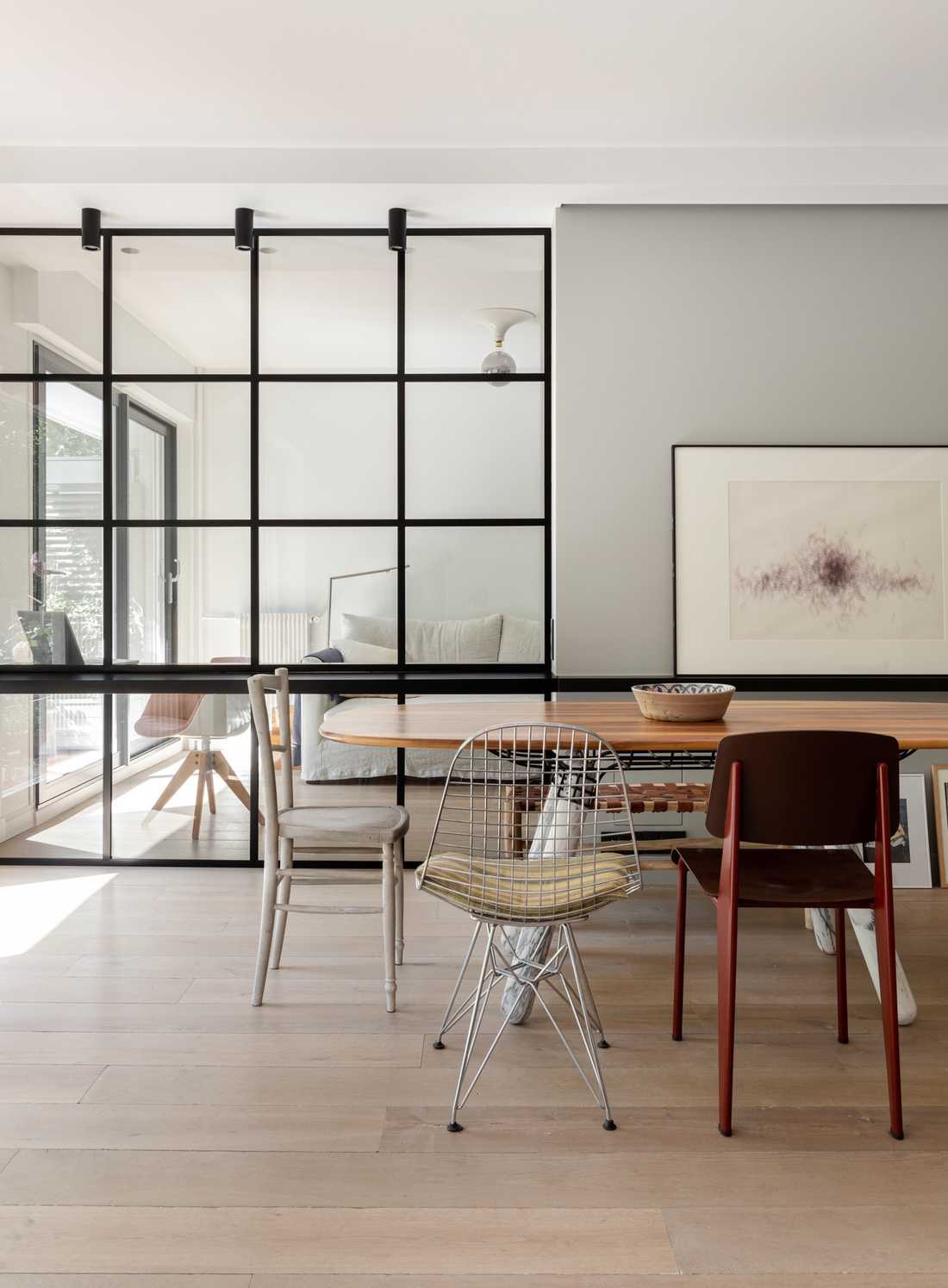 Custom-made glass roof between bedroom and living room designed by an interior designer